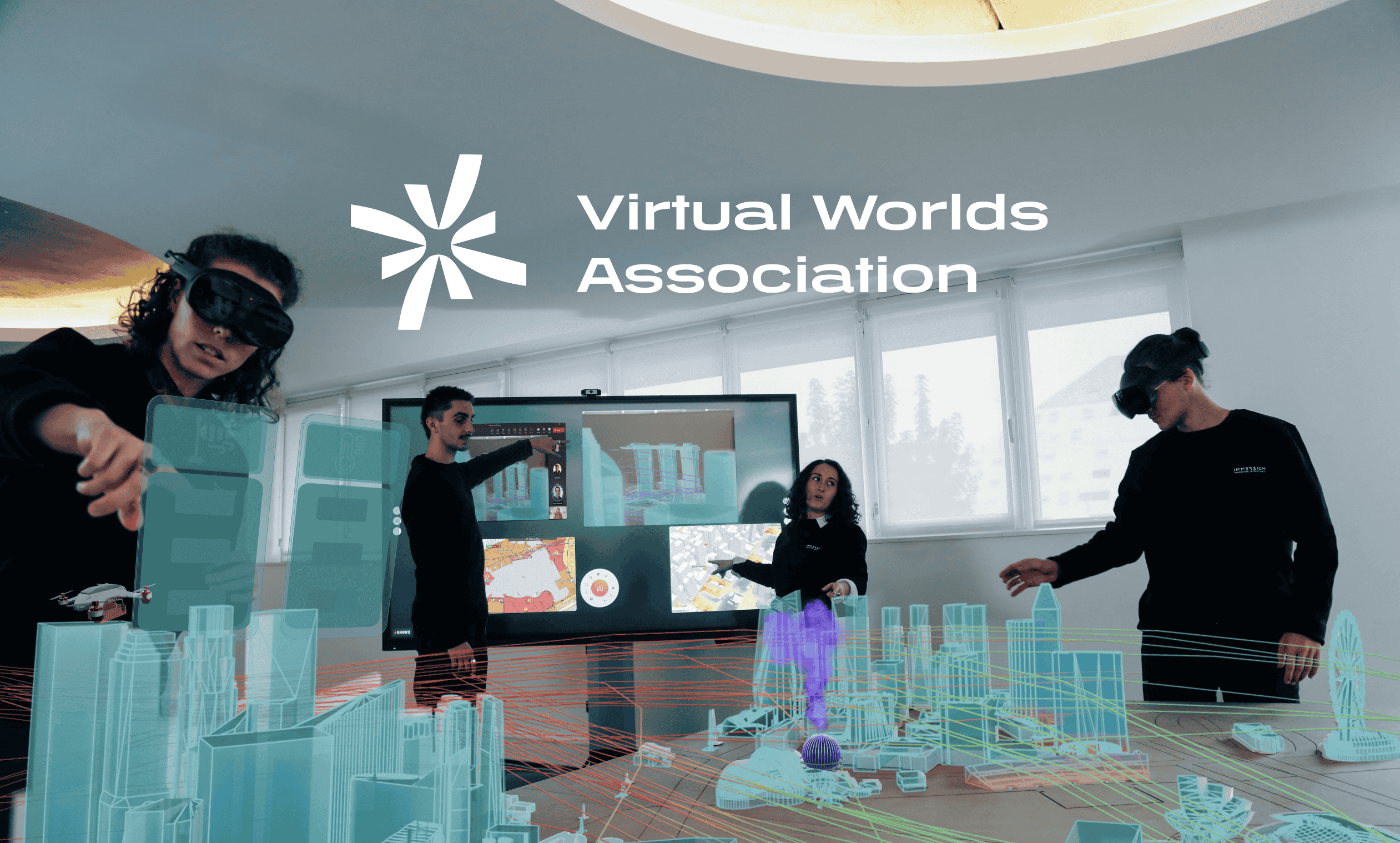Logo of the Virtual Worlds Association in white in front of a group of people working with VR headsets.